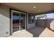 Covered patio with sliding glass doors and ample space for outdoor seating at 18171 W Daley Ln, Surprise, AZ 85387