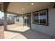 Covered patio with concrete floor, windows and sliding glass door entrance to home at 18171 W Daley Ln, Surprise, AZ 85387