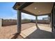 Covered back patio with concrete flooring and block wall fenced yard at 18171 W Daley Ln, Surprise, AZ 85387