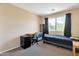 Cozy bedroom with a modern desk, convenient mini-fridge, and a bright window view at 18601 N 16Th Pl, Phoenix, AZ 85024