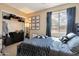 Well-lit bedroom features posters, built-in closet, and window with natural light at 18601 N 16Th Pl, Phoenix, AZ 85024