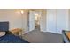 Bedroom featuring a walk-in closet and a glimpse into the adjacent bathroom at 18601 N 16Th Pl, Phoenix, AZ 85024