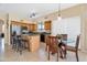 Eat-in kitchen with center island, light wood cabinets, stainless appliances, and a dining area with a round table at 18601 N 16Th Pl, Phoenix, AZ 85024