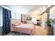 Bedroom with unique lighting, featuring a pink bedspread, and a home office space at 18829 N 23Rd Ave, Phoenix, AZ 85027