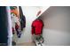 Walk-in closet with shelving and hanging space, filled with a variety of clothing items at 18829 N 23Rd Ave, Phoenix, AZ 85027