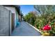 Charming home exterior featuring a blue bench and lush garden along the side of the house at 18829 N 23Rd Ave, Phoenix, AZ 85027