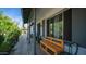 Inviting front porch with gray trim, a painted brick facade, a bench and potted plants at 18829 N 23Rd Ave, Phoenix, AZ 85027