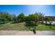 Spacious front yard with mature trees, green grass, and a red mailbox on a sunny day at 18829 N 23Rd Ave, Phoenix, AZ 85027