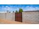 Wooden gate set within a cinder block wall, providing a secure entry point to the property at 18829 N 23Rd Ave, Phoenix, AZ 85027