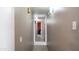 A straight hallway with neutral-colored walls and tile flooring leading to other rooms in the house at 18829 N 23Rd Ave, Phoenix, AZ 85027