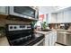 Updated kitchen featuring stainless steel appliances, white cabinets, and a black cooktop at 18829 N 23Rd Ave, Phoenix, AZ 85027