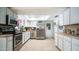 Bright kitchen with white cabinetry, stainless steel appliances, and a skylight at 18829 N 23Rd Ave, Phoenix, AZ 85027
