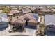 Stunning aerial view showcasing a home with solar panels, lush landscaping, and a private backyard at 24127 N 166Th Ct, Surprise, AZ 85387