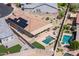 Backyard patio featuring a covered dining area, desert landscaping, artificial grass, and a small pool at 24127 N 166Th Ct, Surprise, AZ 85387