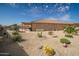Expansive backyard featuring desert landscaping, a covered patio, and ample space for outdoor activities at 24127 N 166Th Ct, Surprise, AZ 85387
