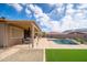 Lush backyard with a sparkling pool and covered patio at 24127 N 166Th Ct, Surprise, AZ 85387
