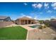 Private backyard features an artificial lawn, pool and patio at 24127 N 166Th Ct, Surprise, AZ 85387