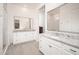 Bathroom showcasing double vanity sinks, granite countertops, framed mirrors, and walk-in shower at 24127 N 166Th Ct, Surprise, AZ 85387