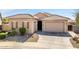 Charming single-story home featuring a tile roof, multiple garage spaces and desert landscaping at 24127 N 166Th Ct, Surprise, AZ 85387