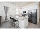 Modern kitchen with stainless steel appliances, granite countertops, and stylish bar seating at 24127 N 166Th Ct, Surprise, AZ 85387