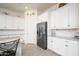 Bright kitchen features white cabinets, stainless steel appliances, and granite countertops with a subway tile backsplash at 24127 N 166Th Ct, Surprise, AZ 85387
