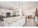 Kitchen with granite countertop island, white cabinets, modern appliances and an open floorplan at 24127 N 166Th Ct, Surprise, AZ 85387