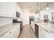 Modern kitchen with white cabinets, granite countertops, stainless steel appliances and subway tile backsplash at 24127 N 166Th Ct, Surprise, AZ 85387