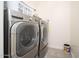 Convenient laundry room with newer front-loading washer and dryer, maximizing efficiency at 24127 N 166Th Ct, Surprise, AZ 85387