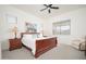 Comfortable main bedroom with a king bed, neutral carpet, a ceiling fan, and two windows at 24127 N 166Th Ct, Surprise, AZ 85387