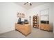Home office setup with modern desk, bookshelf, and natural lighting creates a productive workspace at 24127 N 166Th Ct, Surprise, AZ 85387