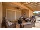Relaxing outdoor living space featuring comfortable seating, a ceiling fan, and a stylish decor at 24127 N 166Th Ct, Surprise, AZ 85387