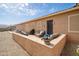 Welcoming outdoor patio with cozy seating area, ideal for enjoying the backyard and outdoor living at 24127 N 166Th Ct, Surprise, AZ 85387