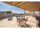 Charming covered patio with outdoor seating, perfect for relaxation and overlooking the sparkling pool at 24127 N 166Th Ct, Surprise, AZ 85387