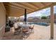 Outdoor dining and seating area with a pool view at 24127 N 166Th Ct, Surprise, AZ 85387