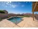 Sparkling pool with a cascading waterfall, surrounded by a well-maintained patio and lush landscaping at 24127 N 166Th Ct, Surprise, AZ 85387