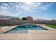 Inviting pool area with a tranquil waterfall, offering a refreshing oasis in the backyard at 24127 N 166Th Ct, Surprise, AZ 85387