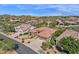 Impressive aerial view of a desert home highlighting its well-maintained landscaping, tile roof, and desert surroundings at 26521 N 114Th Pl, Scottsdale, AZ 85255