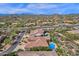 Expansive aerial view of a desert community showcasing custom homes with sparkling pools and mountain views at 26521 N 114Th Pl, Scottsdale, AZ 85255