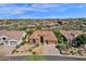 Beautiful aerial view of a desert home featuring a tile roof, desert landscaping, and a circular driveway at 26521 N 114Th Pl, Scottsdale, AZ 85255