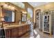 Elegant bathroom featuring dual sinks, custom cabinetry, and unique glass block accents for natural light at 26521 N 114Th Pl, Scottsdale, AZ 85255