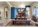 Dining room area with rustic wood table and bench seating, view into kitchen at 26521 N 114Th Pl, Scottsdale, AZ 85255
