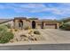 Single level home showcasing desert landscaping, mature trees, and a two car garage at 26521 N 114Th Pl, Scottsdale, AZ 85255