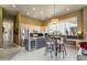 Open kitchen with stainless steel appliances, large granite island, and adjacent dining area at 26521 N 114Th Pl, Scottsdale, AZ 85255