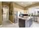 Eat-in kitchen with stone countertops, stainless appliances and view of hallway at 26521 N 114Th Pl, Scottsdale, AZ 85255