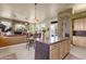 Kitchen with granite countertops, tan cabinets, an island, and stainless steel appliances at 26521 N 114Th Pl, Scottsdale, AZ 85255