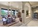 Open concept living room and dining area, chandelier, large picture windows and comfortable seating at 26521 N 114Th Pl, Scottsdale, AZ 85255