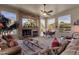 Living room showcasing a stone fireplace and comfortable seating arrangement at 26521 N 114Th Pl, Scottsdale, AZ 85255
