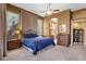 Well-lit main bedroom with large windows, ceiling fan, and classic furnishings, offering a serene ambiance at 26521 N 114Th Pl, Scottsdale, AZ 85255