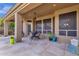 Covered patio with comfortable seating, ideal for outdoor dining and relaxation, enhanced by a ceiling fan at 26521 N 114Th Pl, Scottsdale, AZ 85255
