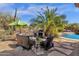 Inviting backyard patio with comfortable seating, fire pit, and lush landscaping, ideal for outdoor gatherings at 26521 N 114Th Pl, Scottsdale, AZ 85255